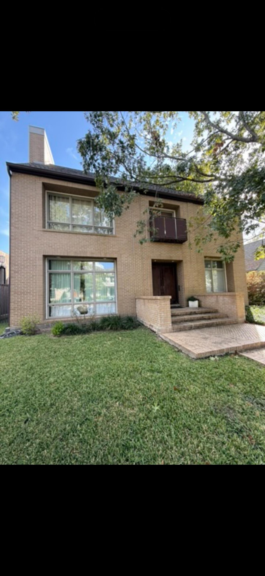 Two-story brick residence front elevation before interior renovation